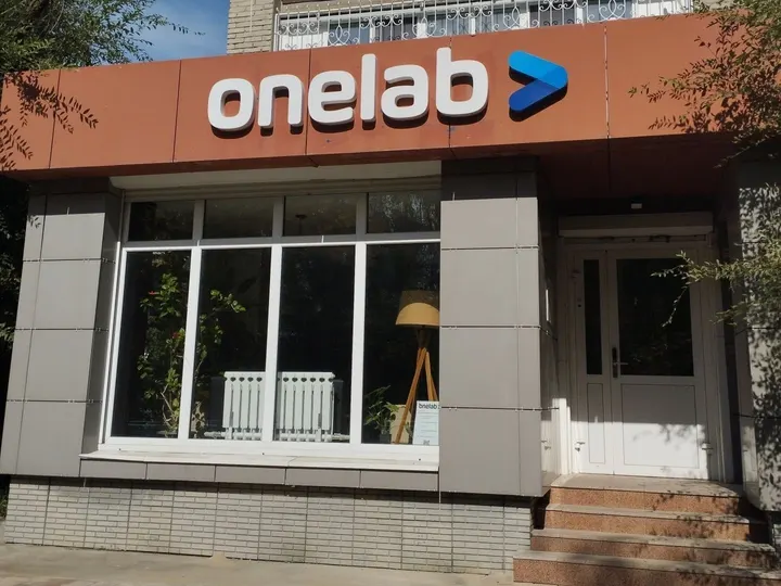 Entrance to the ONELAB head office in Oskemen: the onelab sign above the shop window and door